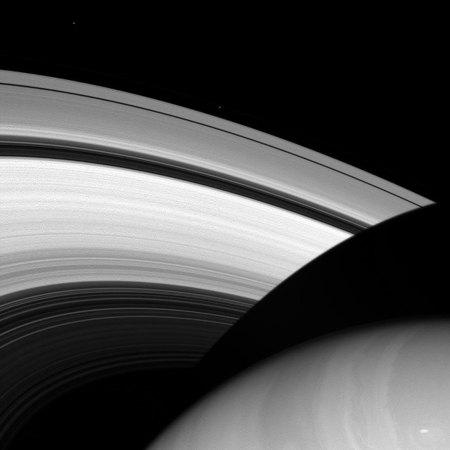 Saturn's S Rings along with its icy moons Prometheus and Epimetheus as tiny specs