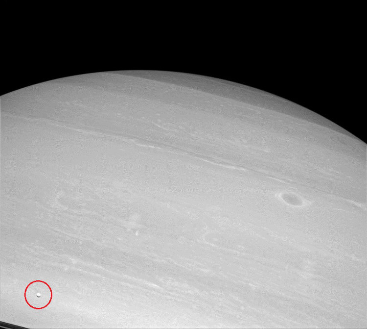 Tiny Enceladus captured with Saturn in the background