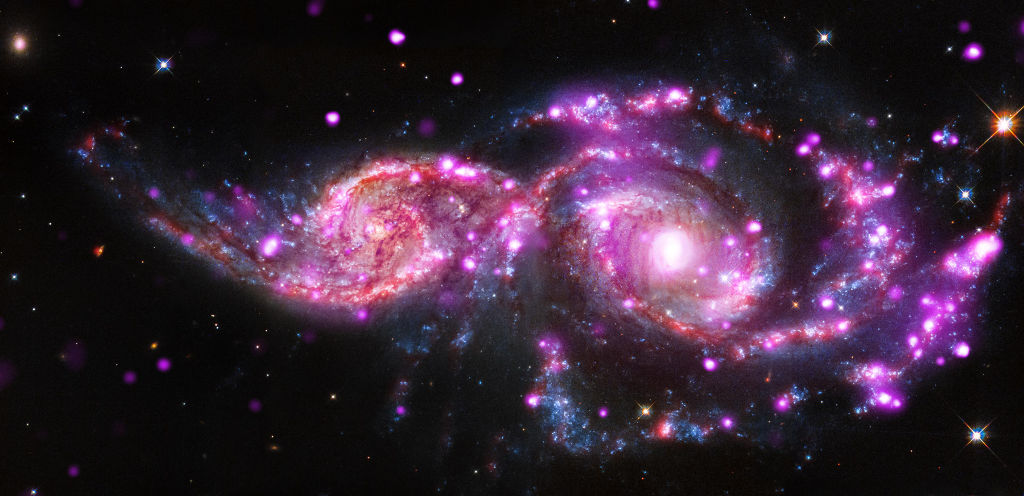 Chandra, Hubble and Spitzer telescopes capture  NGC 2207 and IC 2163 in a wicked lightshow