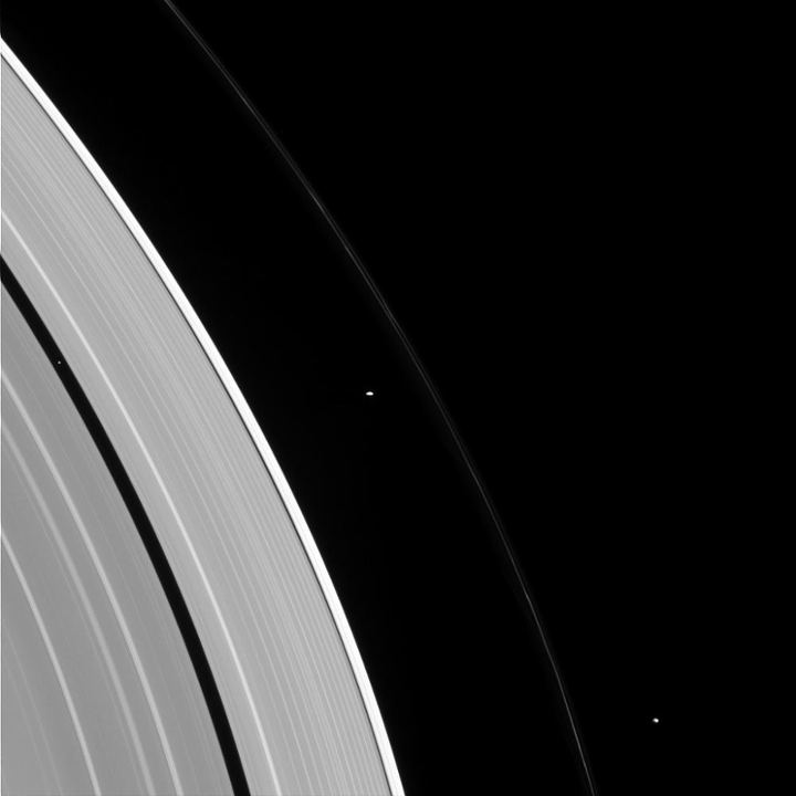 Cassini photographed three of Saturn's moons and its rings